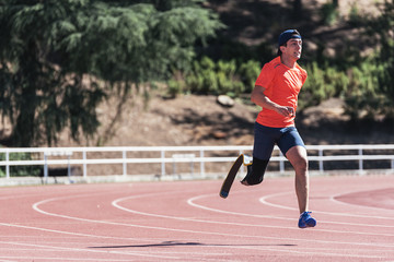 Disabled man athlete training with leg prosthesis.