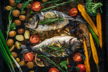 Grilled dorado fish with aromatic herbs and vegetables