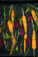 Top view of vegetables for roasting on dark background