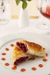 Cherry pie slice arranged on a plate, Wineglass in background, Traditional dessert in elegant setting, Selective focus with soft light