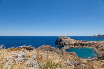 Bay and shore of the city of lindos. Blue water and wonderful beaches of Rhodes island.