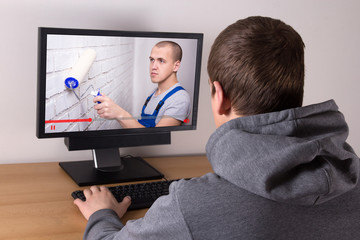 young man watching builder's video blog