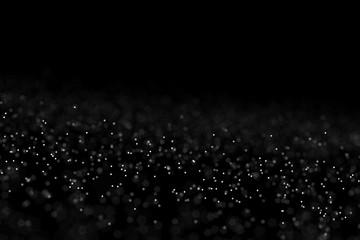 Falling dust cloud design . Particles cloud background, wallpaper with copy space. Rain, snow fall concept . Freeze motion of white powder coming down, isolated on black, dark background.