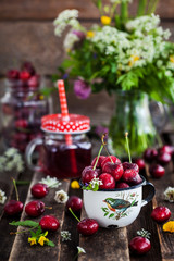 Fresh wet cherry in enamel metal mug