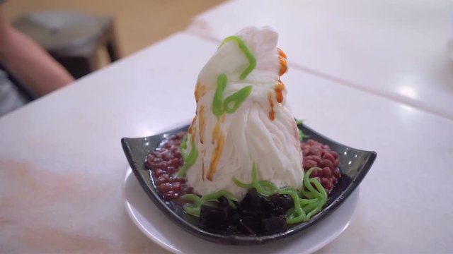 Traditional Singapore called Chendol cold dessert served with coconut, jelly grass and red beans. Also commons in Malaysia Thailand and Vietnam