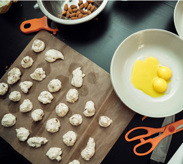 Meringue preparation. Fresh useful sweets on paper for oven.