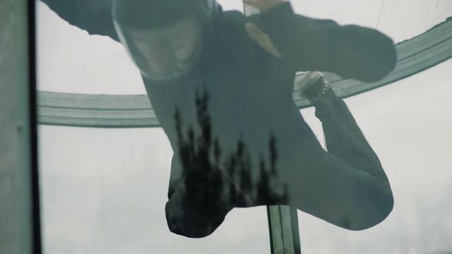 Male skydiver performs tricks in air wind tunnel. Flying in a wind tunnel