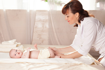 Obraz na płótnie Canvas the little boy baby doctor doing massage