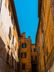 Fototapeta na wymiar historical street at rome with orange facaded buildings