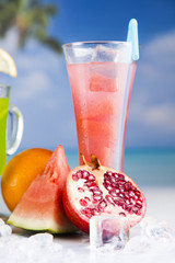Summer drink, palm branch and Fresh tropical fruits