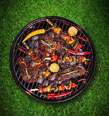 Barbecue grill with beef steaks, close-up.