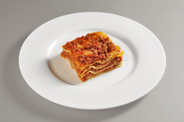 Dish with lasagna portion to meat