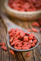 Goji Berries (selective focus) on vintage wooden background