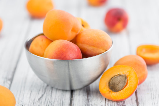 Fresh Apricots on wooden background (selective focus)