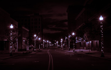 Fototapeta na wymiar Glowing Downtown Street At Night