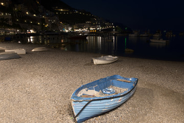 blue lonely old boat on the beach at night
