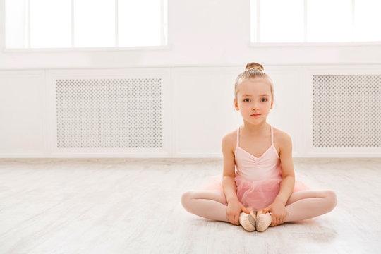 Fototapeta Portrait of little ballerina on floor, copy space