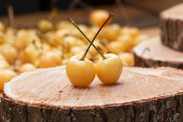 Yellow fresh cherry on a rustic wooden table.