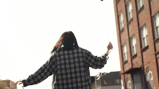 Girl Balances On Train Tracks, Walks Away From Camera, Holding Balloons (Slow Motion)