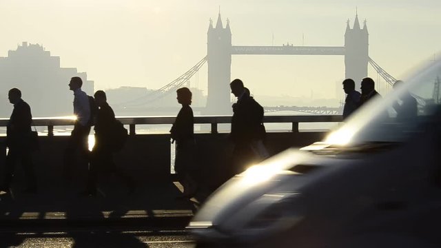UK, England, London, Commuters crossing London Bridge, Tower Bridge beyond