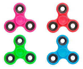 Blue pink green red spinners stress relieving toy isolated on white background