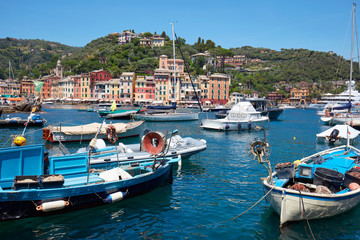 Fototapeta na wymiar Portofino typical beautiful village with colorful houses in Italy, fishing boats