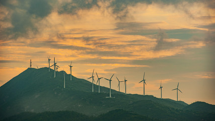 Great sunset with windmills on mountain
