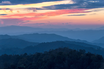 Layer of mountains in the mist at sunset time with burning sky, Nan Province, Thailand