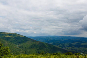 Summer landscape in mountains and the dark blue sky with clouds