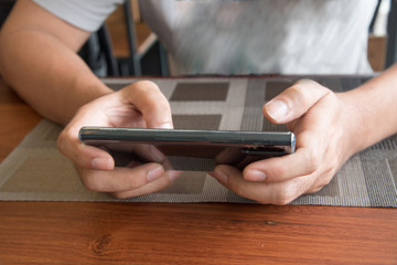 A man use his mobile for playing a game.