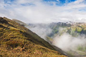 Fototapeta na wymiar Beautiful mountain landscape in fog and blue sky
