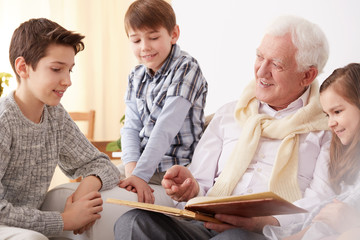 Grandfather showing photos to grandchildren