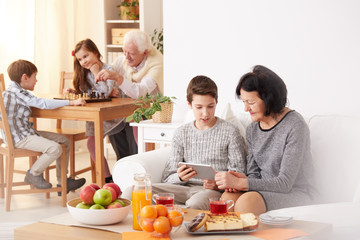 Boy and grandmother using tablet