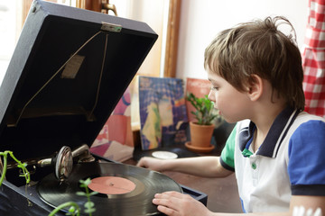 Fototapeta na wymiar Boy playing with gramophone