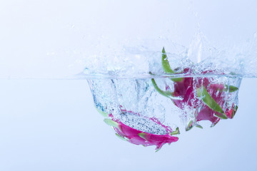 Dragon fruit splashing in water