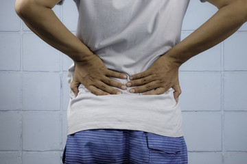 Young man having backache.