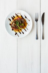 Grilled vegetables salad on white wood