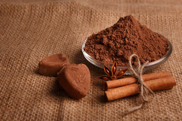 Chocolate heart-shaped candy on a rustic background, chocolate composition