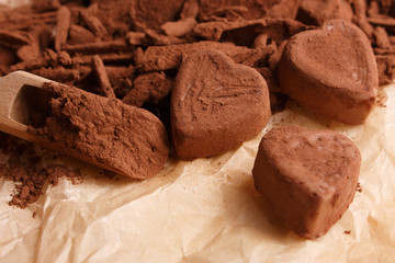 Chocolate heart-shaped candy on a rustic background, chocolate composition