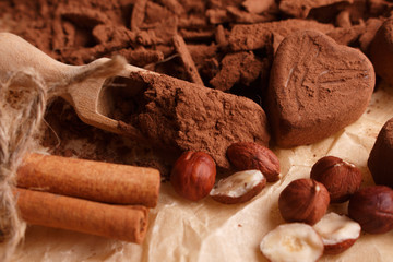 Chocolate heart-shaped candy on a rustic background, chocolate composition