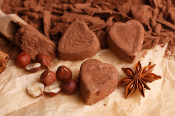 Chocolate heart-shaped candy on a rustic background, chocolate composition