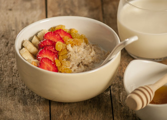 oatmeal porridge with strawberry and banana in a bowl