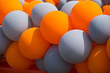 Orange and gray inflatable balls at a celebration activity