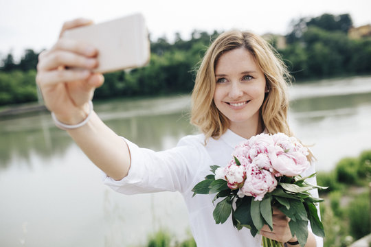 Beautiful woman taking a selfie outdors
