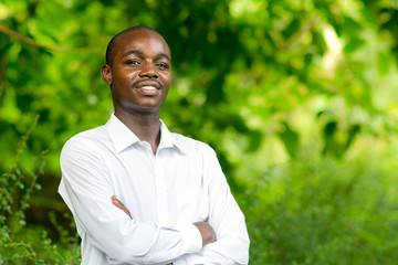 Smile african portrait man in green nature background.