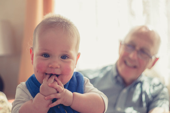 Laughing baby with grandfather