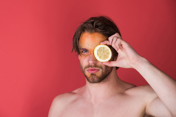 handsome man with creative fashionable makeup hold lemon, vitamin