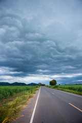 The sky before the storm on paved asphalt road