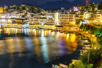 Naklejka premium Agios Nikolaos, one of the most touristic cities on Crete island, at summer evening, Greece.