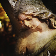 sculpture of an angel with dark background